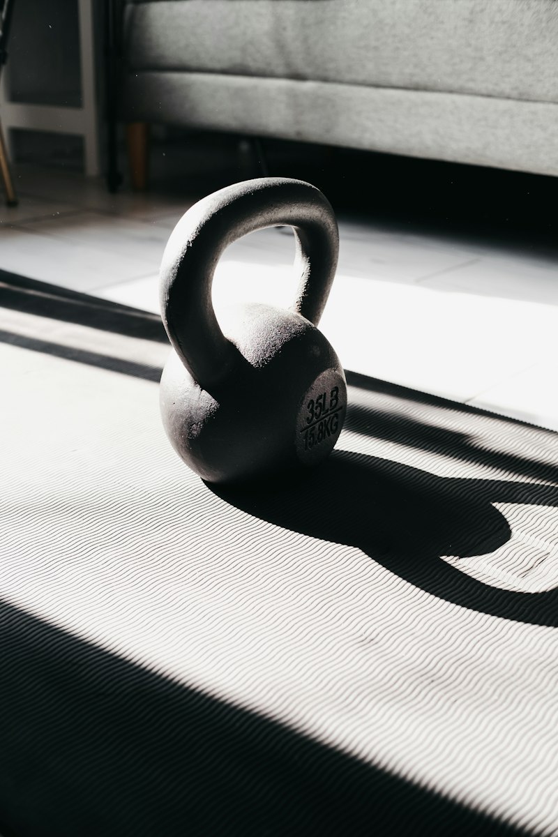 Kettlebell on yoga mat in warm sunlight
