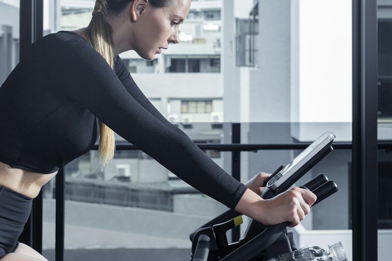 Person on stationary exercise bike at home